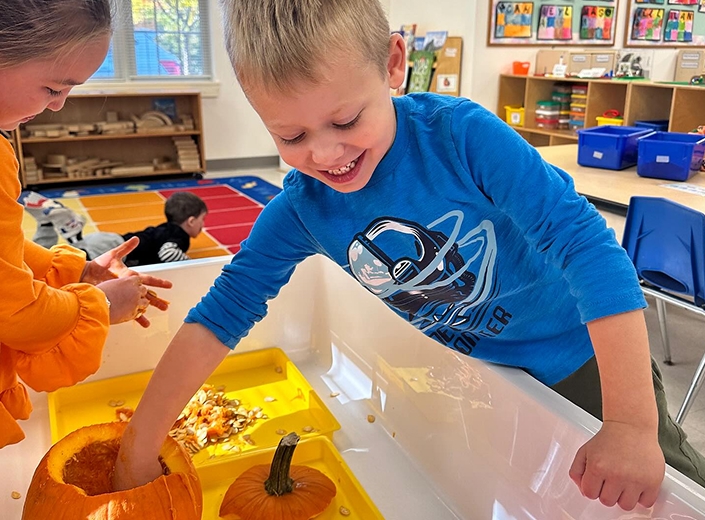 Pre-K students exploring pumpkins