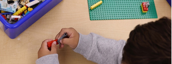 navigating kindergarten boy playing with legos