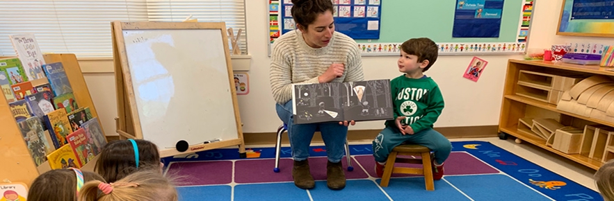 our-school-library-family Mom reading to her son and preschool class